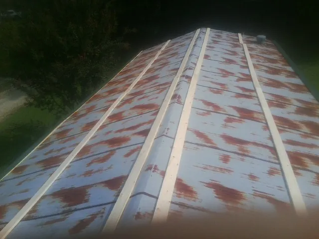 Rusted metal roof panels with new wood purlins before replacement — Storm Damage Roof Repair in Strabane by Roofing Brothers